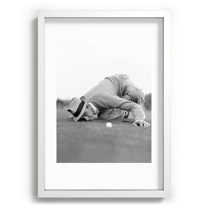 Eye to the ground on the 18th hole; golfing man eyes ball to measure distance to hole vintage black and white portrait photograph - photography - photographs poster Framed Art Print Gallery Image 105