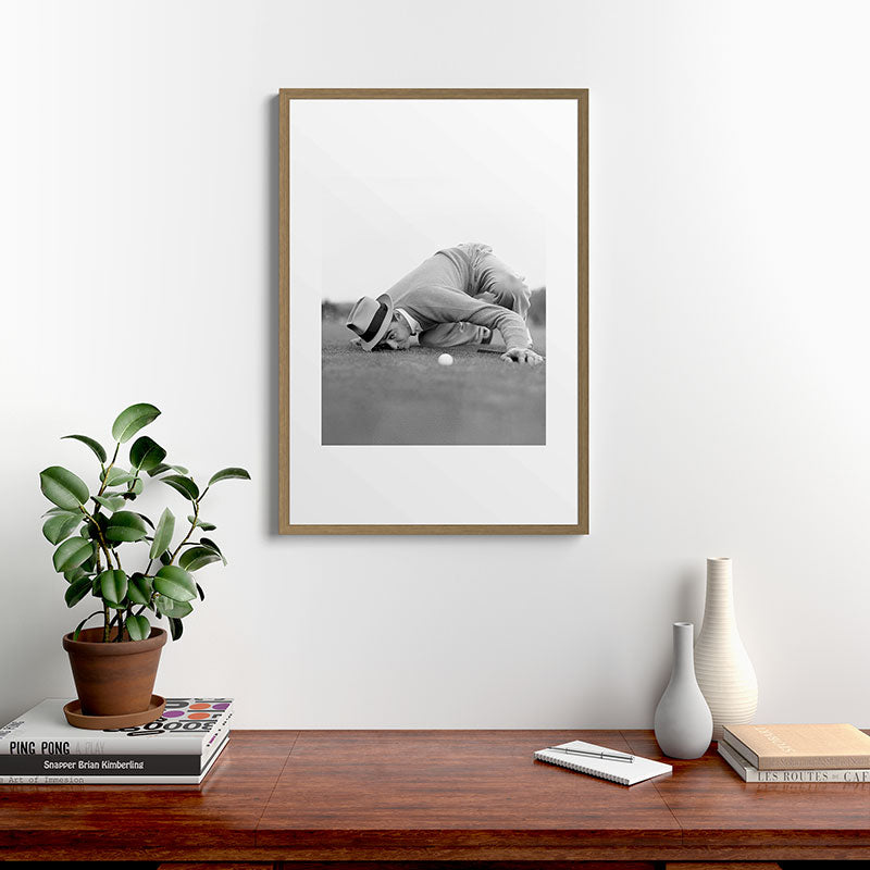 Eye to the ground on the 18th hole; golfing man eyes ball to measure distance to hole vintage black and white portrait photograph - photography - photographs poster Framed Art Print Gallery Image 18