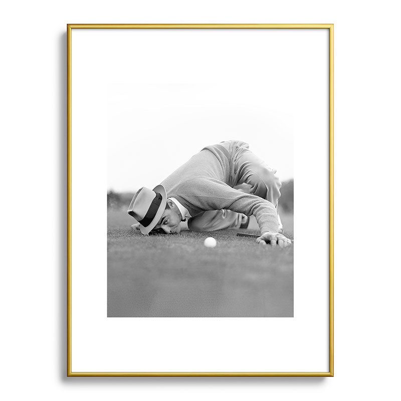 Eye to the ground on the 18th hole; golfing man eyes ball to measure distance to hole vintage black and white portrait photograph - photography - photographs poster Framed Art Print Gallery Image 124