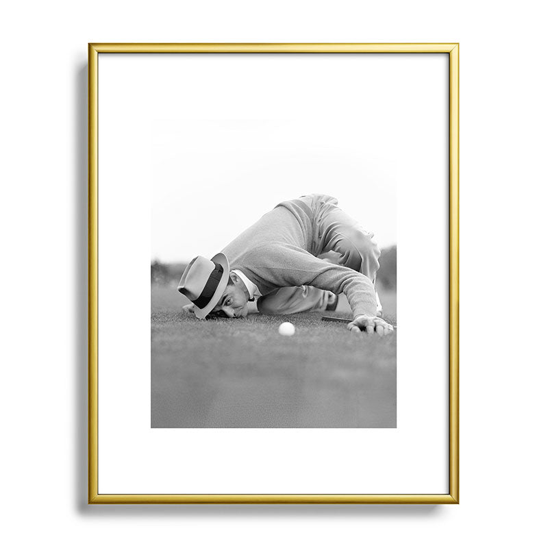 Eye to the ground on the 18th hole; golfing man eyes ball to measure distance to hole vintage black and white portrait photograph - photography - photographs poster Framed Art Print Gallery Image 121