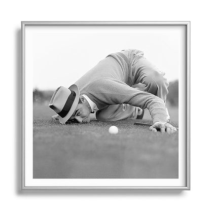 Eye to the ground on the 18th hole; golfing man eyes ball to measure distance to hole vintage black and white portrait photograph - photography - photographs poster Framed Art Print Gallery Image 140