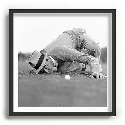 Eye to the ground on the 18th hole; golfing man eyes ball to measure distance to hole vintage black and white portrait photograph - photography - photographs poster Framed Art Print Gallery Image 93